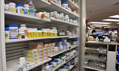 A shelf of drugs is displayed at a pharmacy