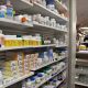 A shelf of drugs is displayed at a pharmacy