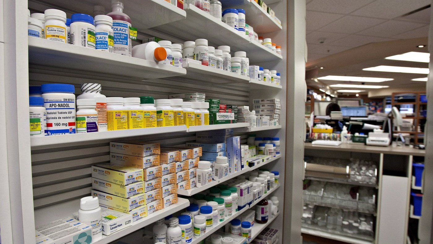 A shelf of drugs is displayed at a pharmacy