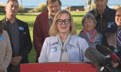 Karin Kirkpatrick speaks at a podium