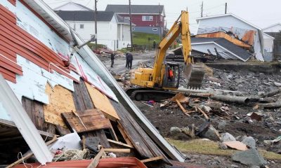 A heavy machinery operator continues the cleanup from the post-tropical storm in Port aux Basques, N.L., Sept.29, 2022