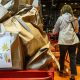 A cart is filled with pre-filled bags of food, during a Thanksgiving food drive