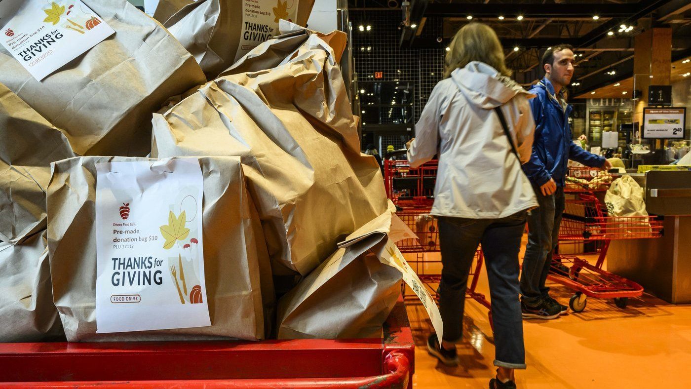 A cart is filled with pre-filled bags of food, during a Thanksgiving food drive