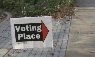 A "voting place" sign on the street