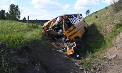 A crashed school bus in a ditch