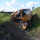 A crashed school bus in a ditch