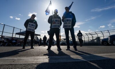 Workers picket at Neptune Terminal during an International Longshore and Warehouse Union labour dispute in North Vancouver, on Tuesday.