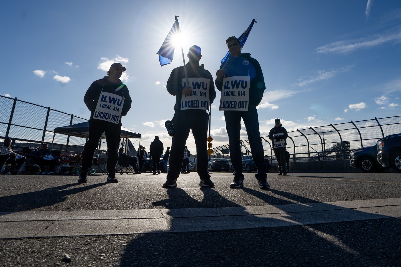 Workers picket at Neptune Terminal during an International Longshore and Warehouse Union labour dispute in North Vancouver, on Tuesday.