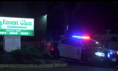 A Hamilton police cruiser is seen outside an apartment building on Main Street West