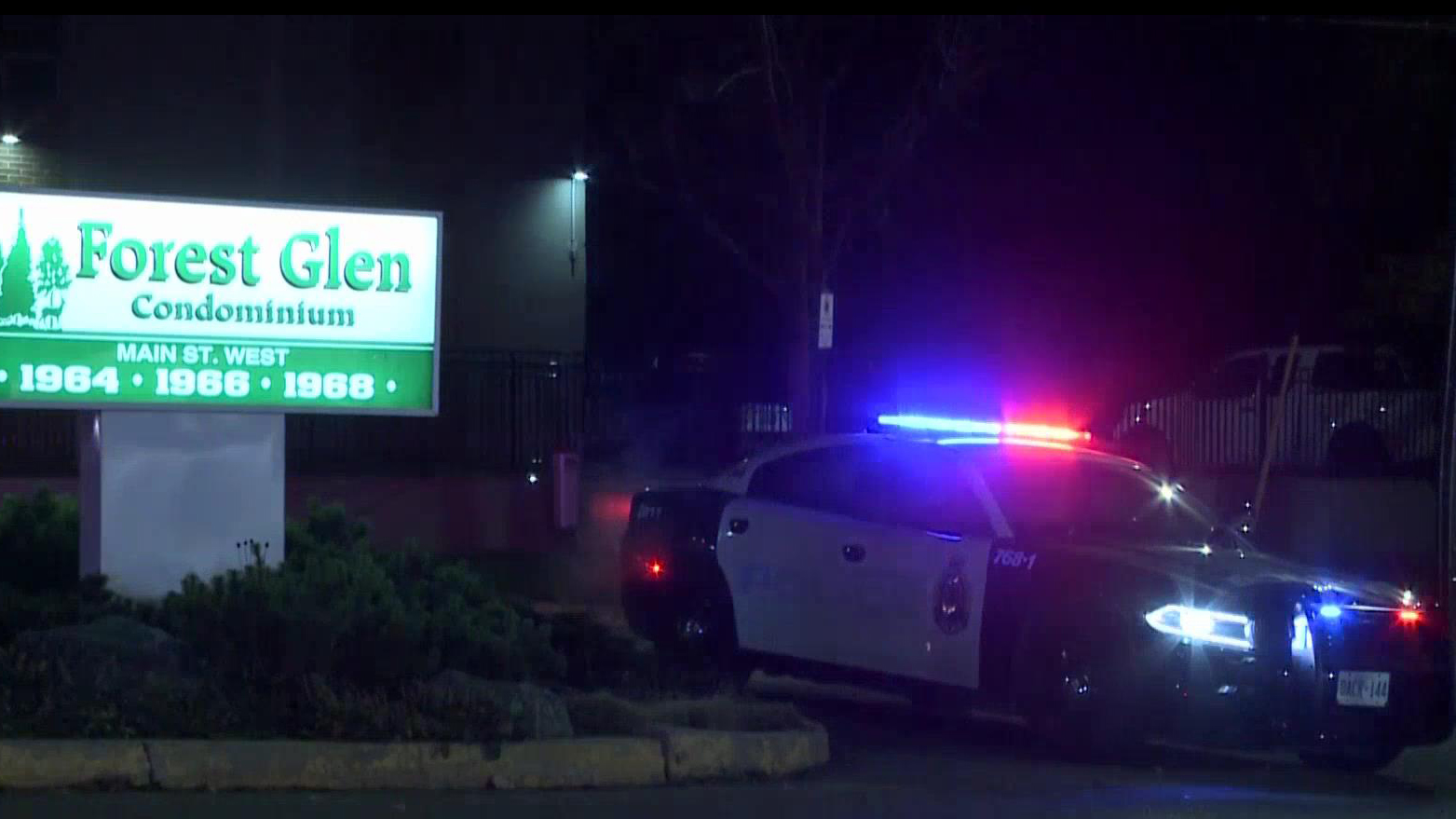 A Hamilton police cruiser is seen outside an apartment building on Main Street West