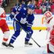 Detroit Red Wings' goaltender Cam Talbot (39) makes a save as Moritz Seider (53) and Toronto Maple Leafs' Matthew Knies (23) look on