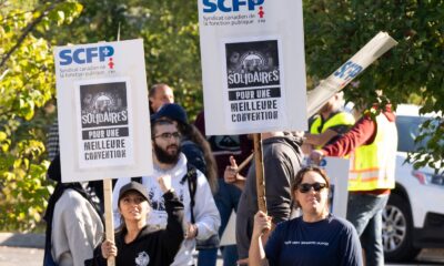 Port of Montreal workers walk a picket line outside the Maisonneuve Termont terminal in Montreal on Sept. 30, 2024