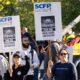 Port of Montreal workers walk a picket line outside the Maisonneuve Termont terminal in Montreal on Sept. 30, 2024