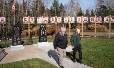 Cousins Victor Harvie, left, and Richard Harvie at a new memorial honouring the war service of their fathers and uncles in the small community of Noel, N.S., on Nov. 4, 2024