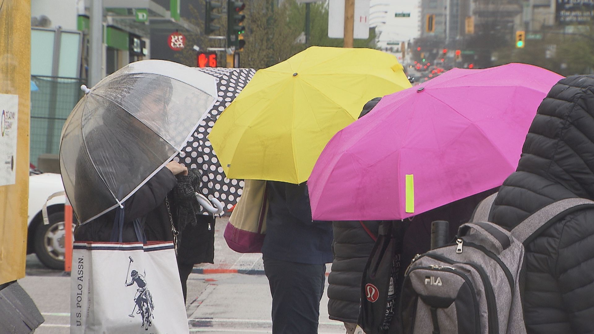 Vancouverites carry colourful umbrellas on a rainy day in April 2024.