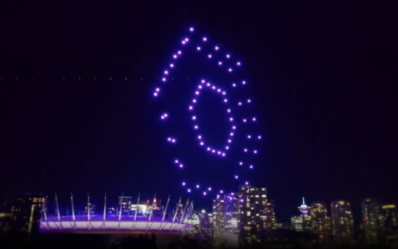 A drone light show flies over BC Place in Vancouver at night