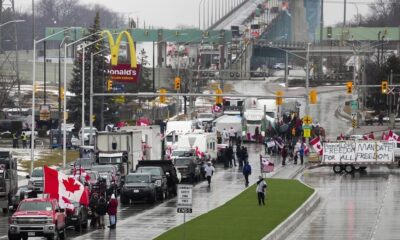 Truckers and supporters block the access leading from the Ambassador Bridge, linking Detroit and Windsor, as truckers and their supporters continue to protest against COVID-19 vaccine mandates and restrictions, in Windsor, Ont., Friday, Feb. 11, 2022.