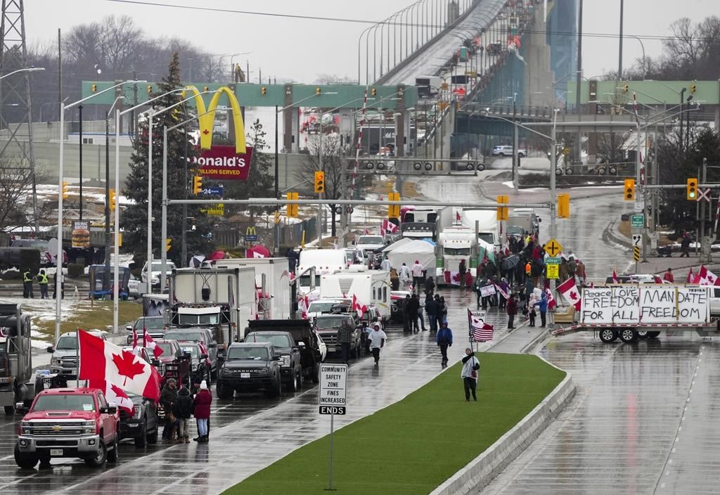 Truckers and supporters block the access leading from the Ambassador Bridge, linking Detroit and Windsor, as truckers and their supporters continue to protest against COVID-19 vaccine mandates and restrictions, in Windsor, Ont., Friday, Feb. 11, 2022.