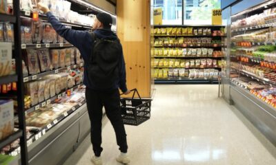 A shopper reaches for groceries at a grocery store in Toronto on May 30, 2024