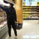 A shopper reaches for groceries at a grocery store in Toronto on May 30, 2024