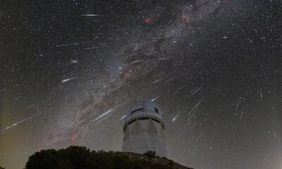 meteors from the Geminid meteor shower streak across the sky above the Nicholas U. Mayall Telescope