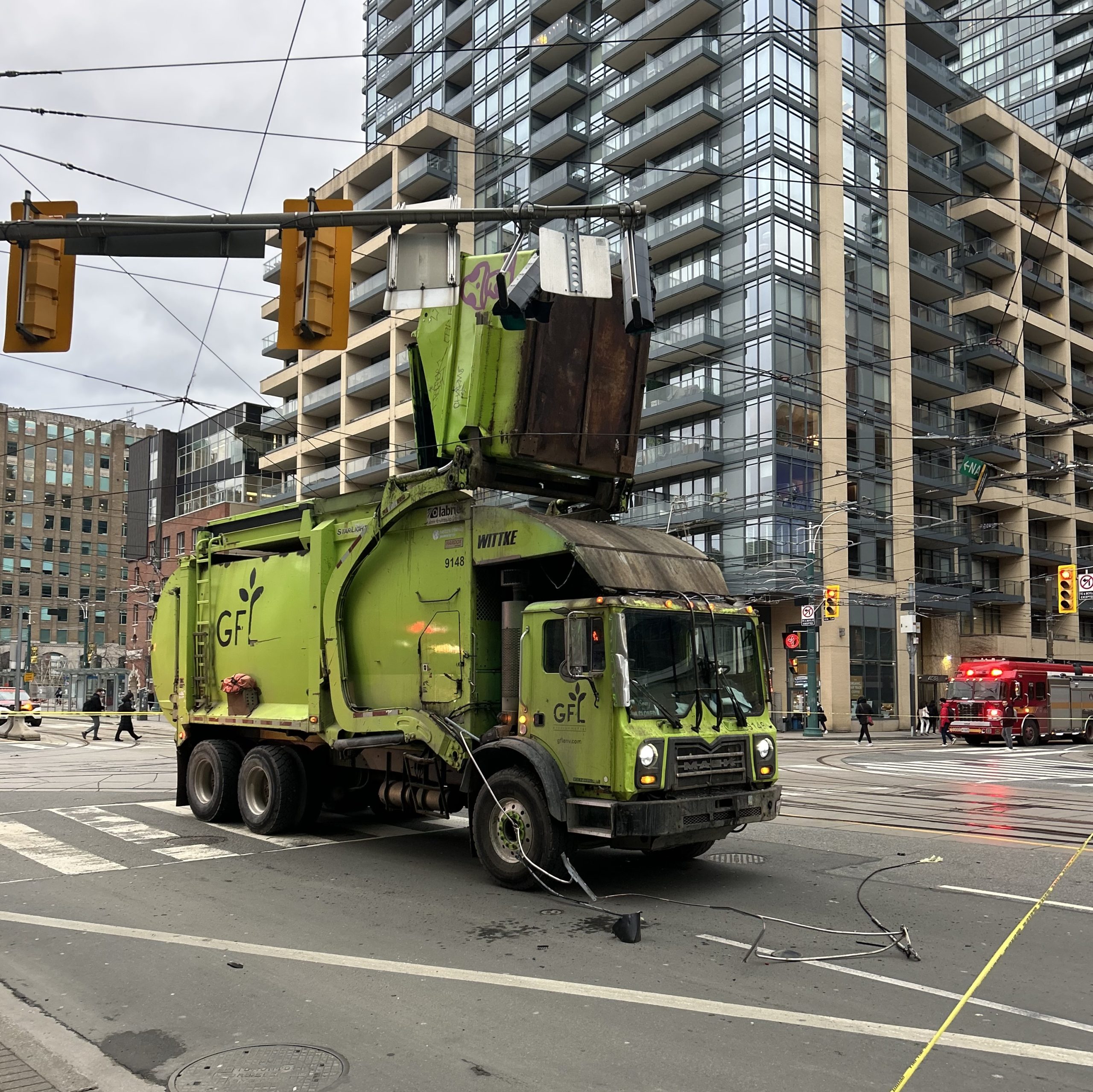 Police say a garbage truck hit TTC streetcar wires at King Street West and Spadina Avenue on Dec. 17, 2024