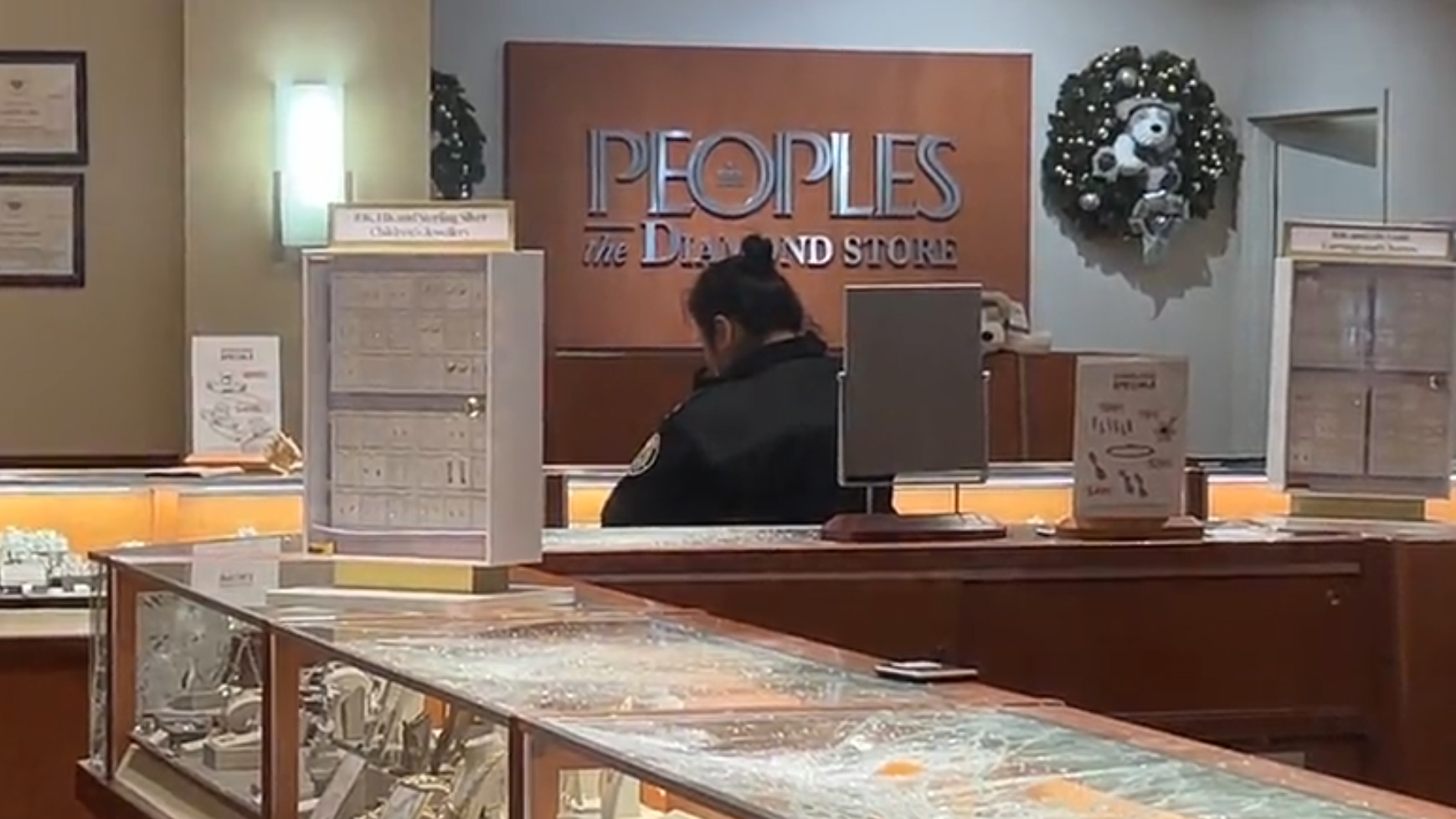 Smashed display cases are seen at the Peoples Jewellers inside Centerpoint Mall in North York