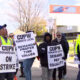 Canada Post workers are seen on a picket line