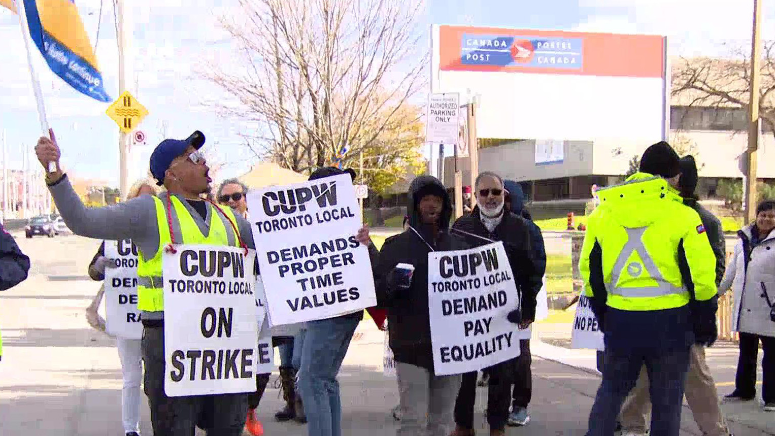 Canada Post workers are seen on a picket line