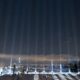 Fourteen beams of light are projected into the sky during a vigil to honour the victims of the 1989 Polytechnique massacre in Montreal on Dec. 6, 2023