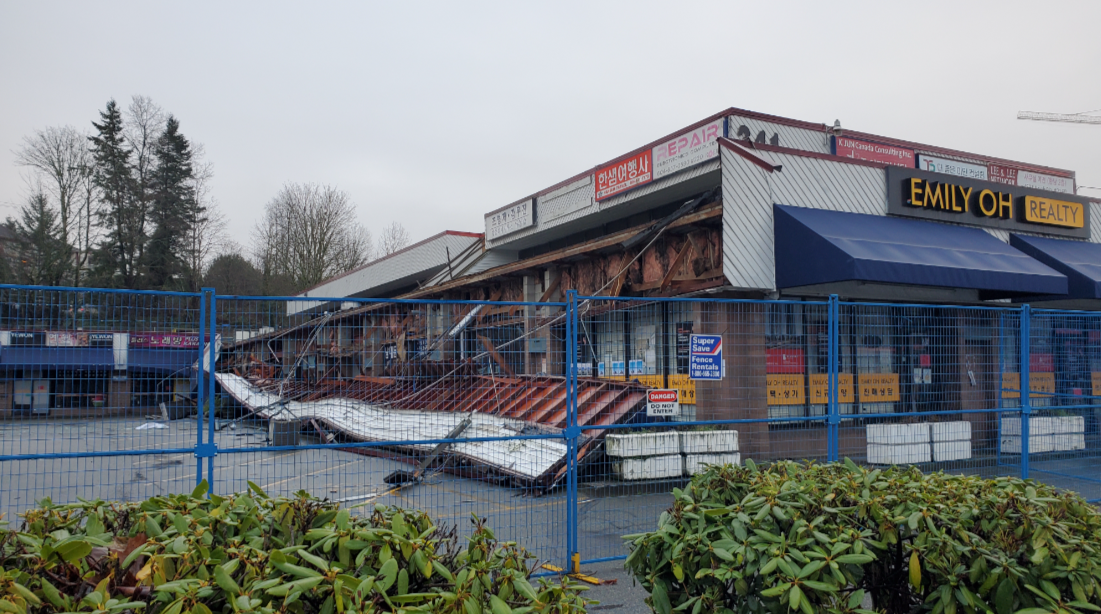 A Coquitlam strip mall remains fenced off on Jan. 5, 2025, a week after a destructive fire.