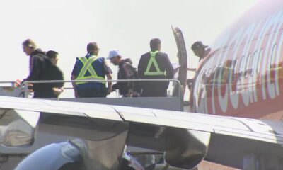 Lionel Messi disembarks a plane.