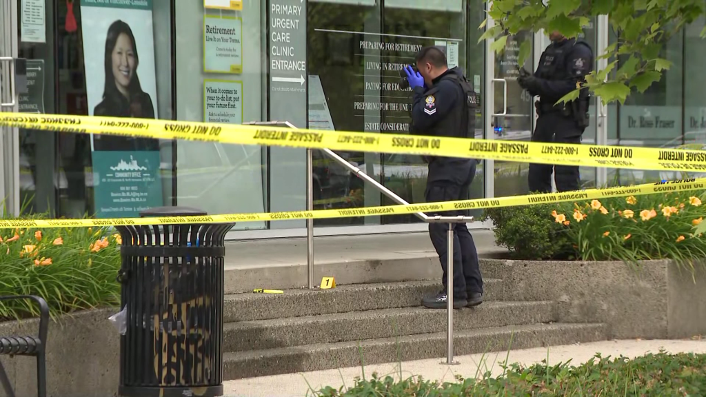Specialized police with the RCMP explosives unit inspect the area around the office of MLA Bowinn Ma on Friday June 27, 2025.