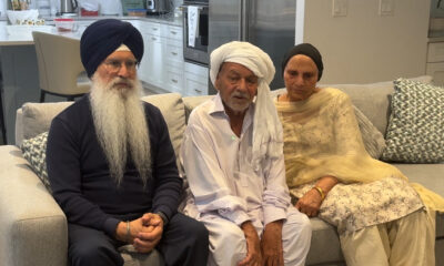 Three people sit on a couch