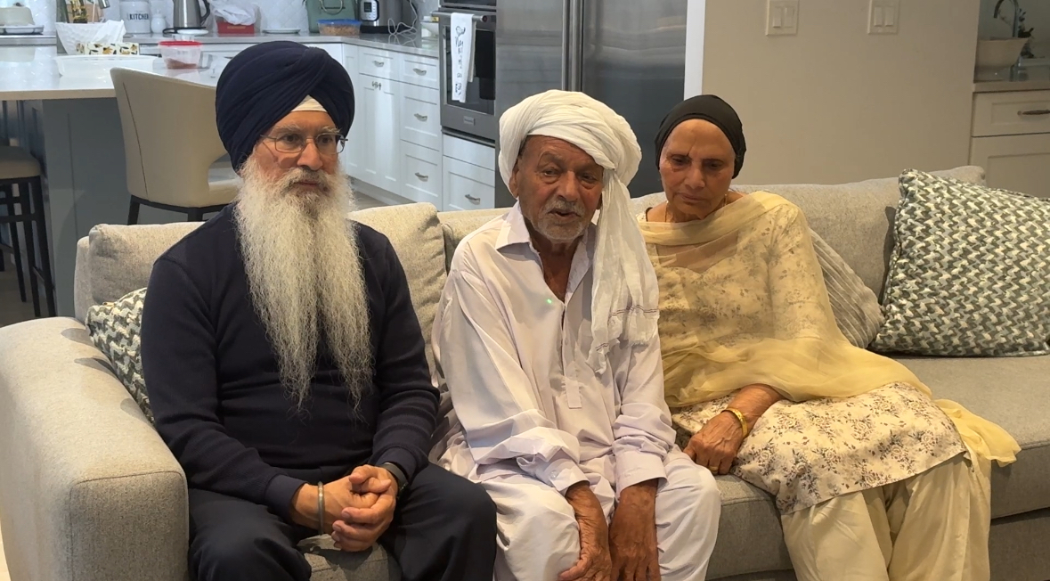 Three people sit on a couch