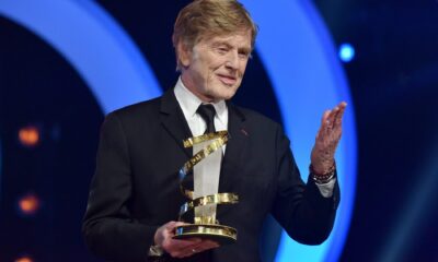 FILE - Director Sydney Pollack, left, appears with actors Robert Redford, center, and Barbra Streisand during the filming of "The Way We Were" in New York on Nov. 28, 1972
