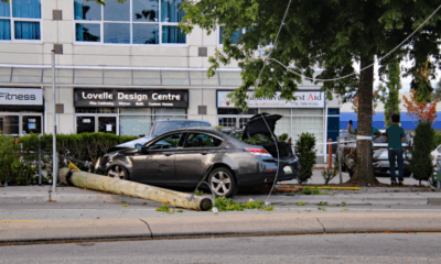 Two people waiting for a bus were injured after a vehicle drove off the road into a hydro pole Saturday evening, the Surrey Police Service (SPS) says.