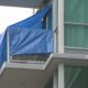 Tarps can be seen covering a balcony on East Esplanade Avenue in North Vancouver after a fatal incident on Aug. 20, 2024.