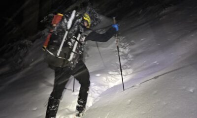An NSR volunteer hikes a snowy trail